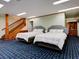Cozy bedroom with two beds, stairs to another level, and a built-in cabinet at 504 Riverside Dr # 504, Tarpon Springs, FL 34689
