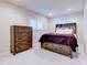 Bedroom features a stylish bed with storage drawers and a matching dresser, complemented by soft carpeting at 504 Riverside Dr # 504, Tarpon Springs, FL 34689