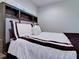 Well-lit bedroom with a stylish bed featuring a built-in headboard, complemented by soft lighting and neutral decor at 504 Riverside Dr # 504, Tarpon Springs, FL 34689