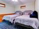 Bedroom features two beds with cozy comforters and blue plaid carpeted flooring at 504 Riverside Dr # 504, Tarpon Springs, FL 34689