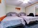 Bedroom featuring two beds, ceiling fan, and a mirrored closet, maximizing space and functionality at 504 Riverside Dr # 504, Tarpon Springs, FL 34689