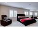 Spacious bedroom featuring a modern platform bed, leather armchair and shuttered windows at 504 Riverside Dr # 504, Tarpon Springs, FL 34689