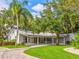 Elegant home with a covered patio, beautiful landscaping, and a circular driveway, perfect for entertaining at 504 Riverside Dr # 504, Tarpon Springs, FL 34689