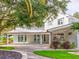 Stately two-story home boasting a brick-paved driveway, a porte-cochere, and lush landscaping at 504 Riverside Dr # 504, Tarpon Springs, FL 34689