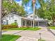 Beautiful two-story home with lush landscaping, a circular driveway, and a well-maintained lawn at 504 Riverside Dr # 504, Tarpon Springs, FL 34689