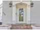 Close up of the front entrance showing a decorative glass front door and sconce lighting at 504 Riverside Dr # 504, Tarpon Springs, FL 34689