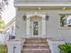 Charming brick home entrance with an ornate glass front door and sconce lighting at 504 Riverside Dr # 504, Tarpon Springs, FL 34689