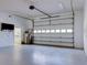 Spacious garage featuring a large door with windows, utility sink, and a wall-mounted television at 504 Riverside Dr # 504, Tarpon Springs, FL 34689