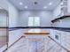 Spacious kitchen with wood plank floors, large center island, stainless refrigerator, and window views at 504 Riverside Dr # 504, Tarpon Springs, FL 34689