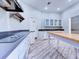 Well-lit kitchen with modern appliances, white cabinets, and light wood-look flooring at 504 Riverside Dr # 504, Tarpon Springs, FL 34689