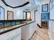 Kitchen with granite countertops, white cabinets, stainless steel appliances, and wood plank floors at 504 Riverside Dr # 504, Tarpon Springs, FL 34689