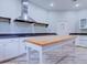 Bright kitchen features stainless steel range hood, light wood island, and shaker-style cabinets at 504 Riverside Dr # 504, Tarpon Springs, FL 34689