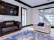 Bright living room featuring a fireplace, large windows, and a comfortable armchair with a blue pillow at 504 Riverside Dr # 504, Tarpon Springs, FL 34689