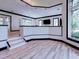 Bright living room featuring white walls and black trim, with stairs leading up to a different level at 504 Riverside Dr # 504, Tarpon Springs, FL 34689
