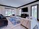 Bright living room features modern furniture, stylish blue rug, and natural light from multiple windows at 504 Riverside Dr # 504, Tarpon Springs, FL 34689