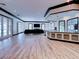 Spacious living room with light-colored flooring, black trim, and large windows at 504 Riverside Dr # 504, Tarpon Springs, FL 34689