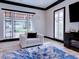 Bright living room features modern furniture, stylish blue rug, and natural light from multiple windows at 504 Riverside Dr # 504, Tarpon Springs, FL 34689