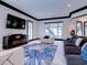 Bright living room features modern furniture, stylish blue rug, and natural light from multiple windows at 504 Riverside Dr # 504, Tarpon Springs, FL 34689