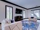 Bright living room features modern furniture, stylish blue rug, and natural light from multiple windows at 504 Riverside Dr # 504, Tarpon Springs, FL 34689