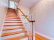Bright staircase with wooden banister and hardwood stairs offers a traditional touch at 504 Riverside Dr # 504, Tarpon Springs, FL 34689