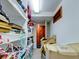 Functional walk-in storage with shelves, boxes, and a door leading to another room at 504 Riverside Dr # 504, Tarpon Springs, FL 34689