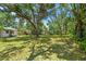 The backyard offers a lush green space shaded by mature trees, perfect for outdoor activities and relaxation at 601 75Th St N, St Petersburg, FL 33710