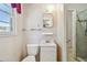 Small bathroom includes white fixtures, a window, and access to tiled shower with safety bar at 601 75Th St N, St Petersburg, FL 33710