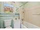 This bathroom offers a vintage tiled backsplash, a toilet, a tub, and a white vanity at 601 75Th St N, St Petersburg, FL 33710