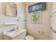 Bathroom featuring neutral walls, white vanity and toilet, and natural light from the window at 601 75Th St N, St Petersburg, FL 33710