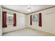 Bright bedroom featuring white trim, white walls, ceiling fan, and natural light from two windows at 601 75Th St N, St Petersburg, FL 33710