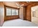A bright bedroom features a brick accent wall, wood-paneled walls, and a large window at 601 75Th St N, St Petersburg, FL 33710