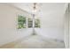 Corner bedroom featuring bright white walls, neutral carpet, and a large window with natural light at 601 75Th St N, St Petersburg, FL 33710