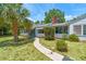 Charming single-story home with a well-manicured lawn, mature landscaping, and a inviting walkway at 601 75Th St N, St Petersburg, FL 33710
