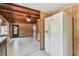 A spacious living room features wood-paneled walls, a ceiling fan, and an adjacent kitchen area at 601 75Th St N, St Petersburg, FL 33710
