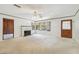 Bright living room featuring a brick fireplace, large windows, and a charming doorway to the left at 601 75Th St N, St Petersburg, FL 33710