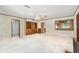 Spacious living room with built-in shelves, neutral carpet, and an opening to the kitchen at 601 75Th St N, St Petersburg, FL 33710