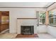 Living room showcasing a vintage brick fireplace, large windows, and classic interior details at 601 75Th St N, St Petersburg, FL 33710