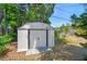 The backyard features a white storage shed, providing practical storage solutions amidst mature greenery at 601 75Th St N, St Petersburg, FL 33710