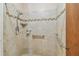 Updated tiled shower with a hand-held showerhead, safety bar, and built-in soap dish at 601 75Th St N, St Petersburg, FL 33710