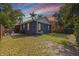 Spacious backyard with a patio area, surrounded by a wooden fence and mature trees at 642 14Th S Ave, St Petersburg, FL 33701