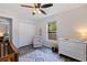 Bedroom featuring a large window, a crib, a white dresser and a cozy chair, and closet at 642 14Th S Ave, St Petersburg, FL 33701
