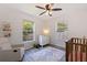 Bedroom featuring two windows, a crib, a white dresser and a cozy chair, bathed in natural light at 642 14Th S Ave, St Petersburg, FL 33701