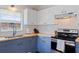 Bright kitchen featuring white cabinets, blue lower cabinets and butcher block countertops at 642 14Th S Ave, St Petersburg, FL 33701
