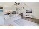 Bright living room with vaulted ceiling, large sectional sofa, ceiling fan, and mounted television at 642 14Th S Ave, St Petersburg, FL 33701