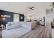 Spacious living room with a large sofa, ceiling fan, stainless steel refrigerator, and an open-concept kitchen at 642 14Th S Ave, St Petersburg, FL 33701