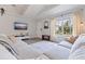 Well-lit living room with a large window, sectional sofa, mounted television, and neutral decor at 642 14Th S Ave, St Petersburg, FL 33701