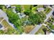 Aerial view of a neighborhood with tree-covered homes and a lake nearby at 6700 14Th N St, St Petersburg, FL 33702