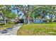 A charming home nestled among mature trees, offering a serene and inviting curb appeal at 6700 14Th N St, St Petersburg, FL 33702