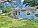 A cozy blue single-story home with a well-manicured lawn and mature landscaping at 6700 14Th N St, St Petersburg, FL 33702