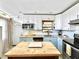 Kitchen features updated cabinets, granite countertops, stainless steel appliances, and a functional island at 6700 14Th N St, St Petersburg, FL 33702
